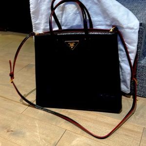 Prada black brushed patent bag with red piping trim. Limited edition